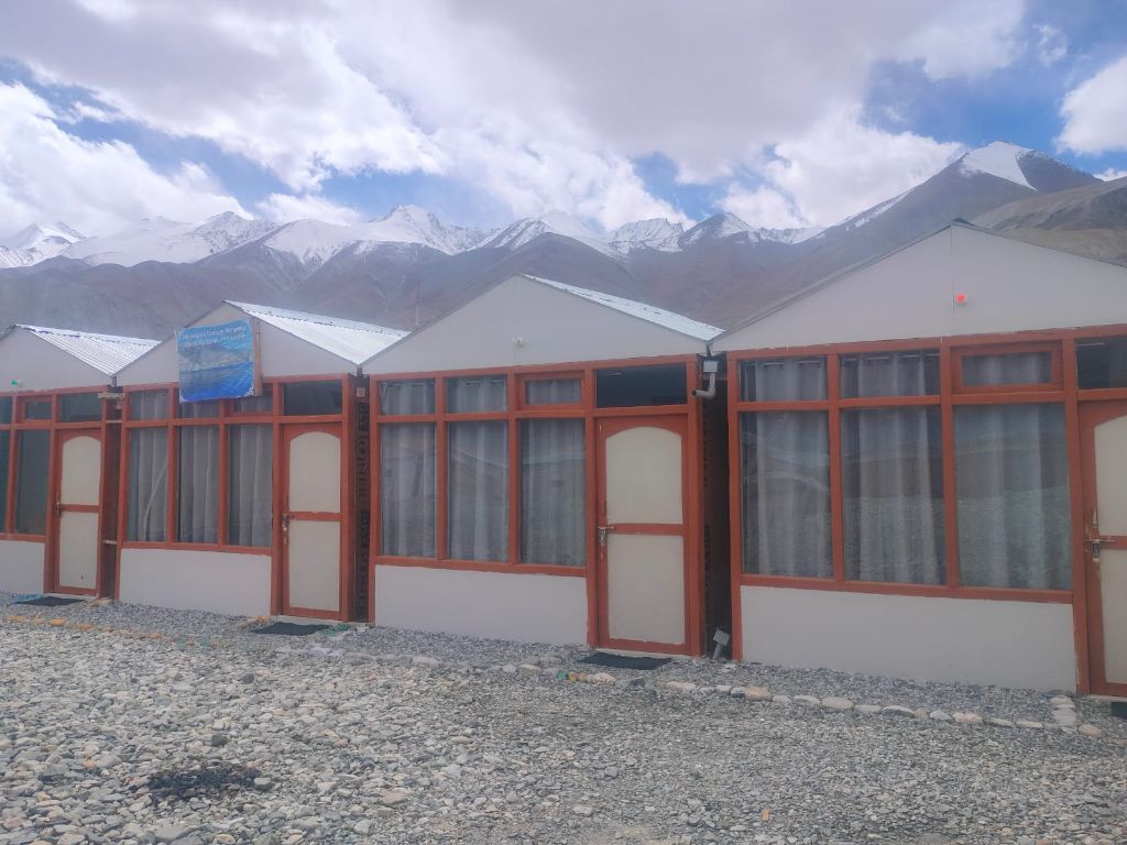 Cottage with snow-capped mountain backdrop