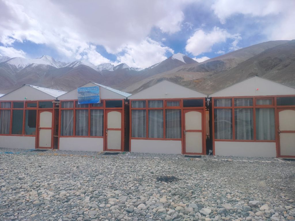 Cottage row with snowy peaks